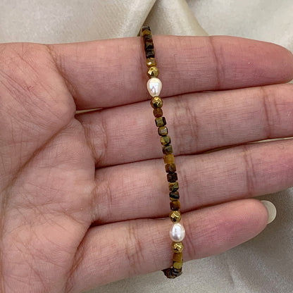 Pulseira em Nylon, com olhos-de-tigre, pérolas barrocas e hematitas douradas